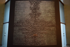 "Give us this day our daily bread" is written around the main prayer in different languages.