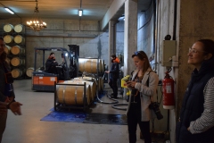 The guys in the background are pumping wine out of the barrels for bottling.