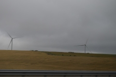 The windmills touch the cloud canopy.